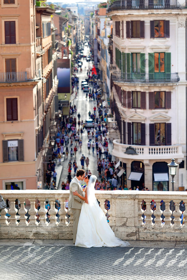 wedding-rome-028 Kissing after the wedding in Piazza di Spagna with the view of Via Condotti in the far distance