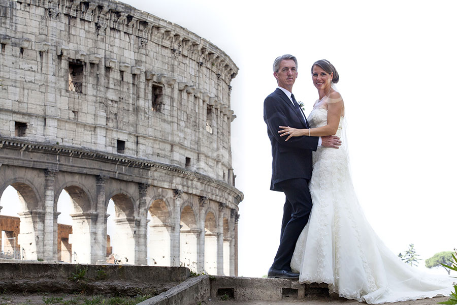 Just married couple photographed in front of the Roman Coliseum 