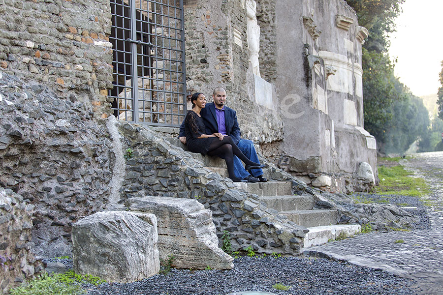 surprise-proposal-21012-009 Couple sitting down and relaxing during a picture session in Italy on ancient Appia