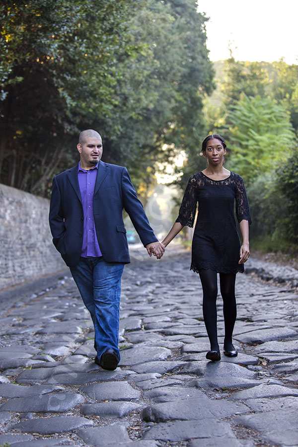 surprise-proposal-21012-013 Walking together holding hands on the ancient Appia road in downtown Italy