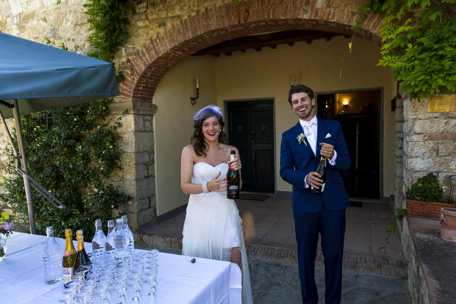 Newlyweds pop opening the wine champagne prosecco