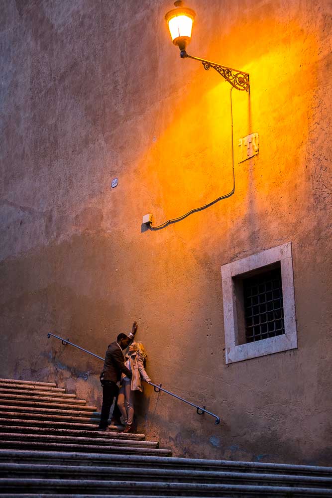 Romantic picture of a couple under roman street light. Romance in Italy.
