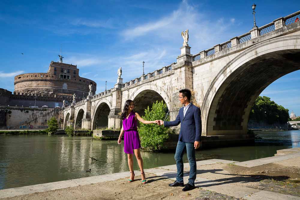 Engagement photo session under Castel Sant Angelo by the Tiber river bank