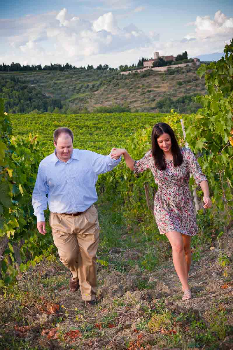 Couple walking hand in hand in a vineyard during a Florence Photographer Tuscany PhotoShoot in Italy