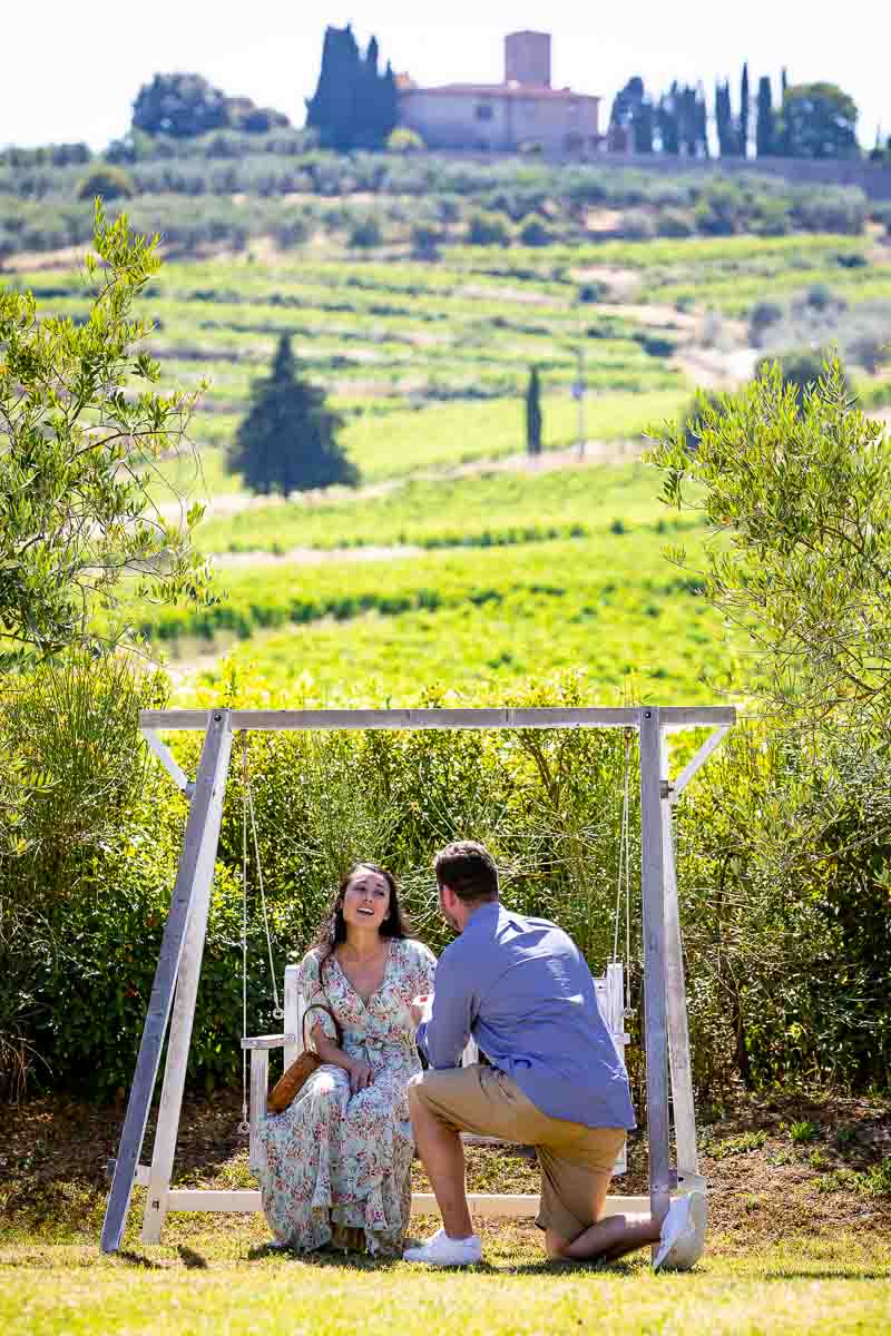 Man kneeling down for a marriage proposition photographed from a distance