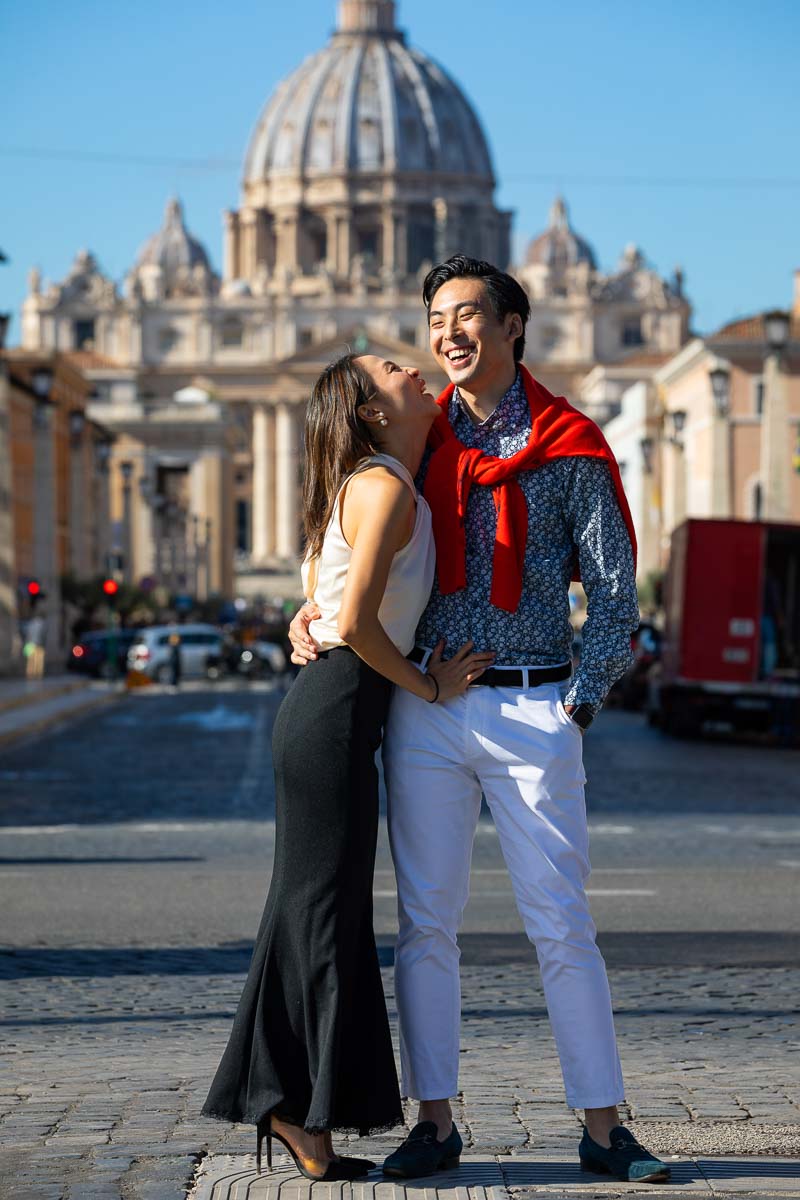 Engagement portrait taken before Saint Peter's cathedral dome in the far background