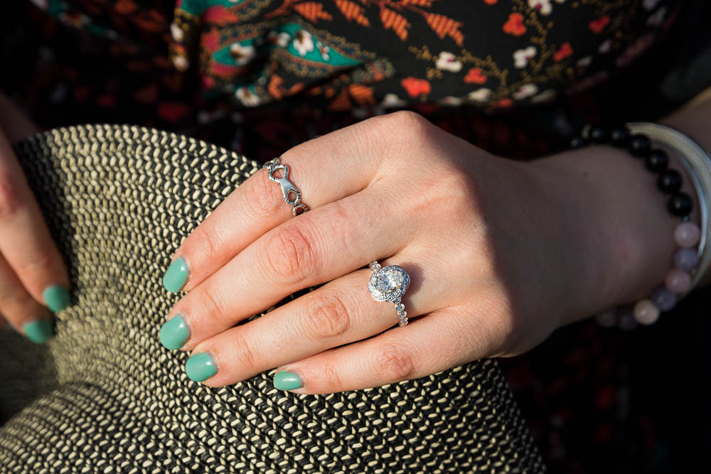 Close up image of the engagement ring wore on the hand