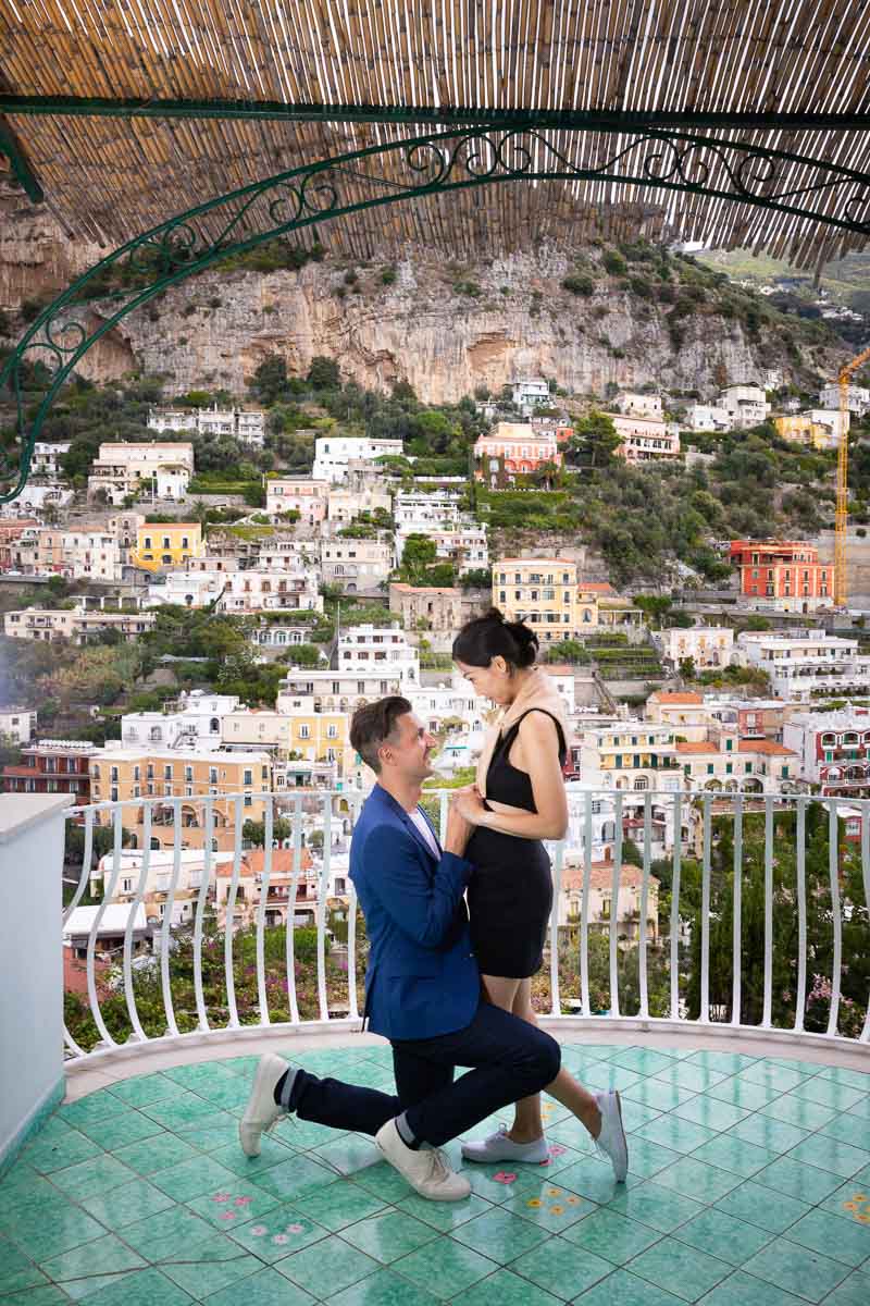 Asking the big question of getting married on a balcony overlooking Positano's houses