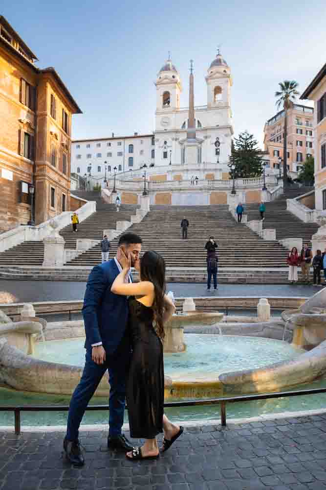 Pictures at Piazza di Spagna by the Barcaccia water fountain with the scenic staircase and church Trinità dei Monti in the background