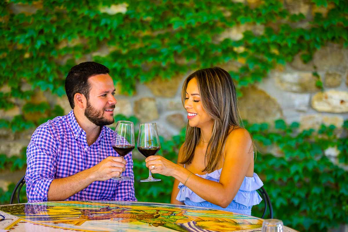Coupe toasting and celebrating their engagement with red wine tasting