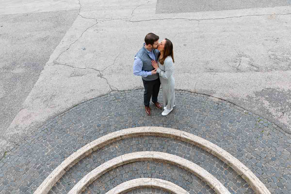 Couple kissing on top of circular geometric steps