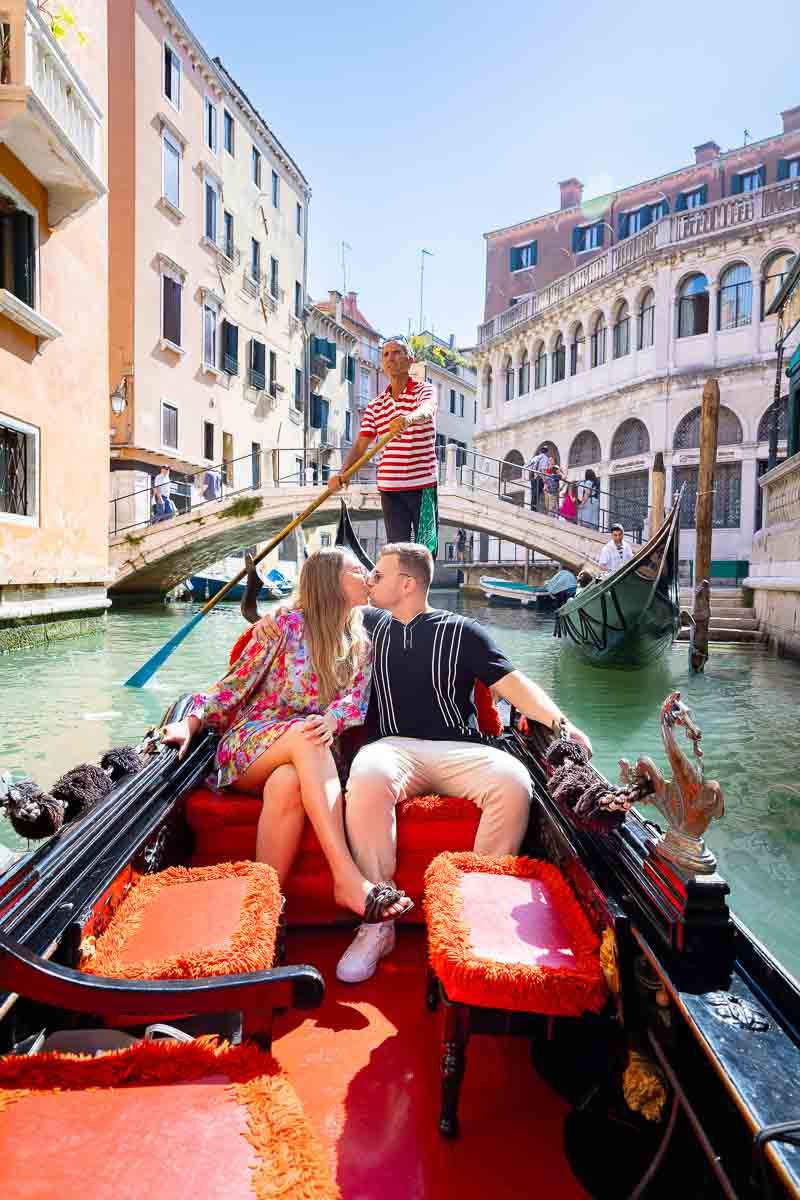 Couple kissing though the Venetian canals 