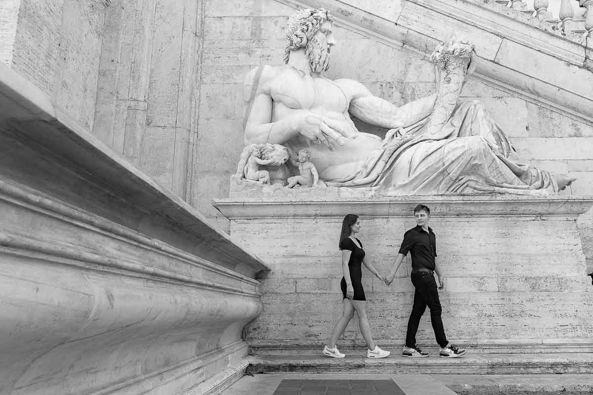 Walking together in Rome after their engagement session in black and white photos 