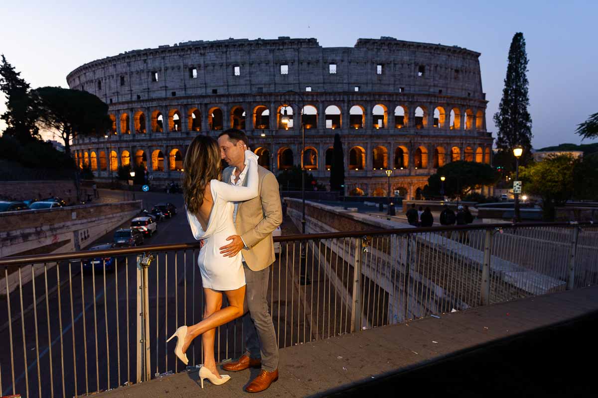 Posing in front Roman Colosseum at sunset 