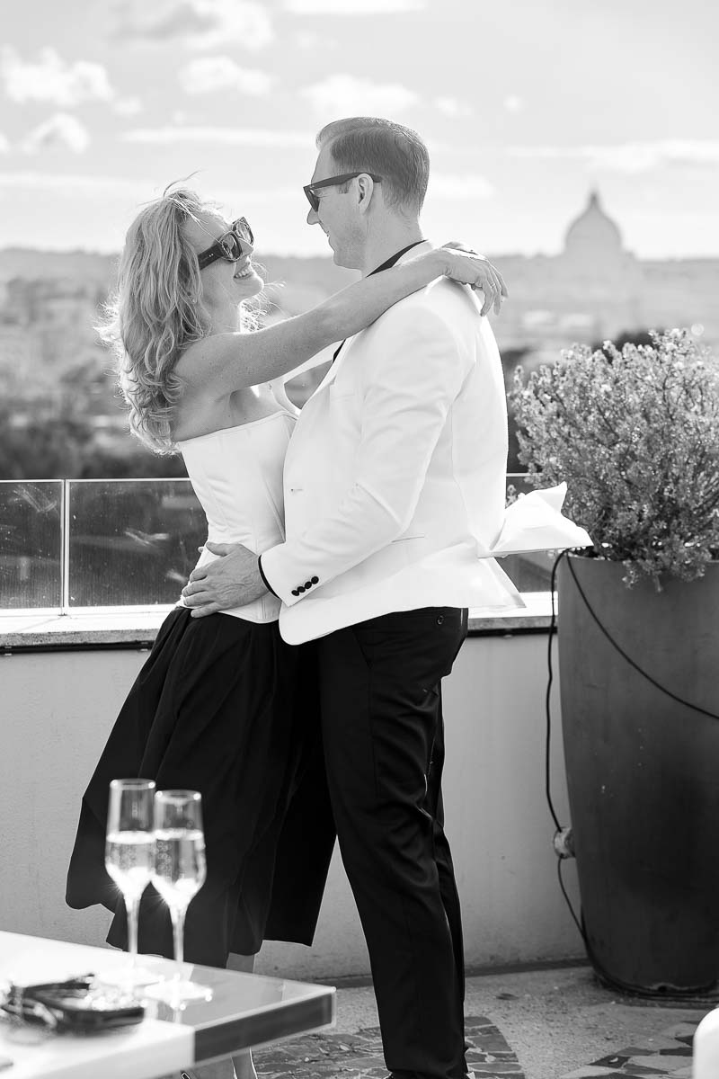 Black and white couple photography in Rome Italy taken on a scenic rooftop with a distant view