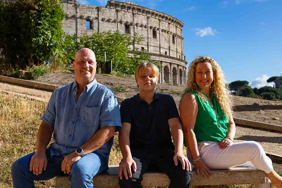 Close up family picture with the Italian Roman Coliseum as backdrop 