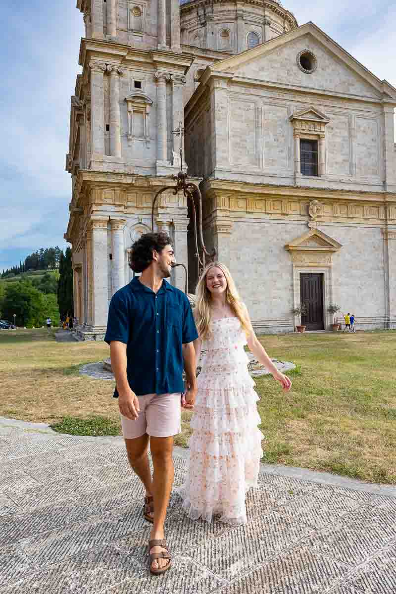 Walking before the church facade during a tuscan photoshoot