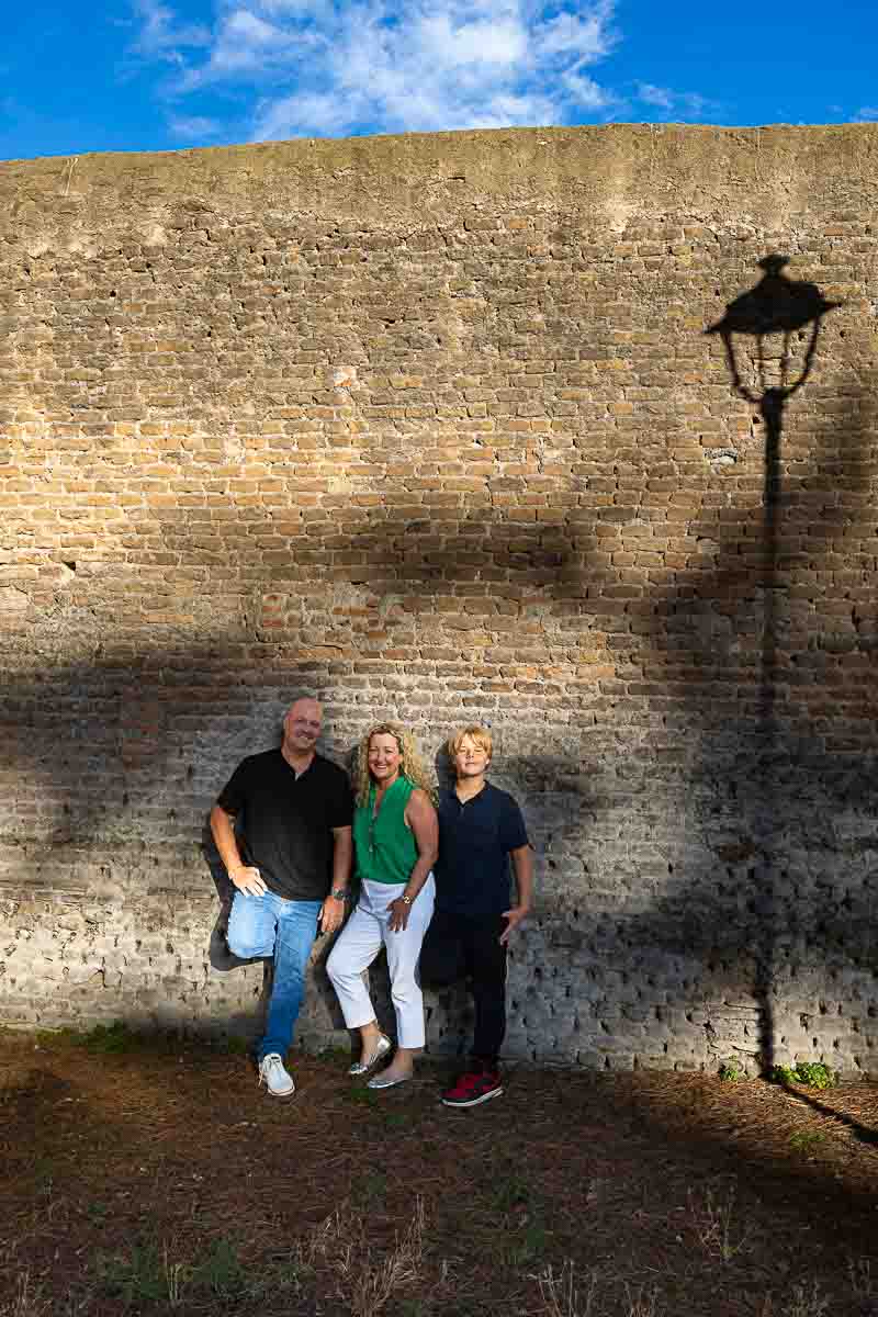 Artistic photography taken against an ancient roman wall with the shadow of a light pole 