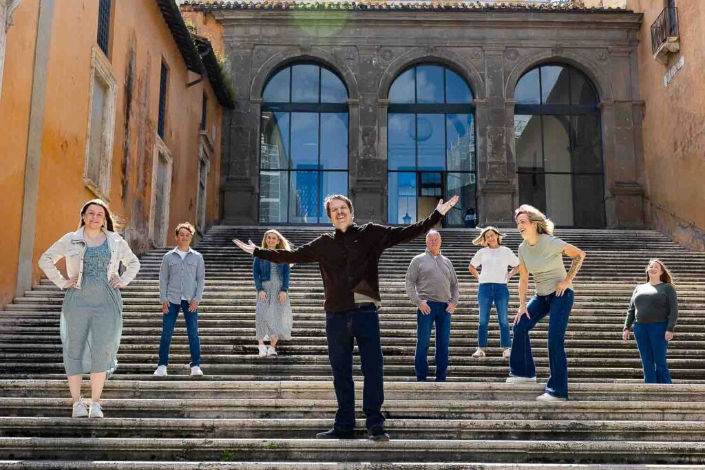 Staircase group photo: A happy family poses on a picturesque staircase during a family photography session in the Eternal City, Rome, Italy.