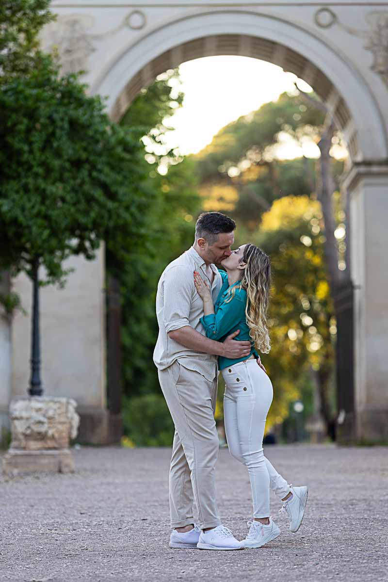 Couple posed during a photography session at the entrance of the roman Borghese park