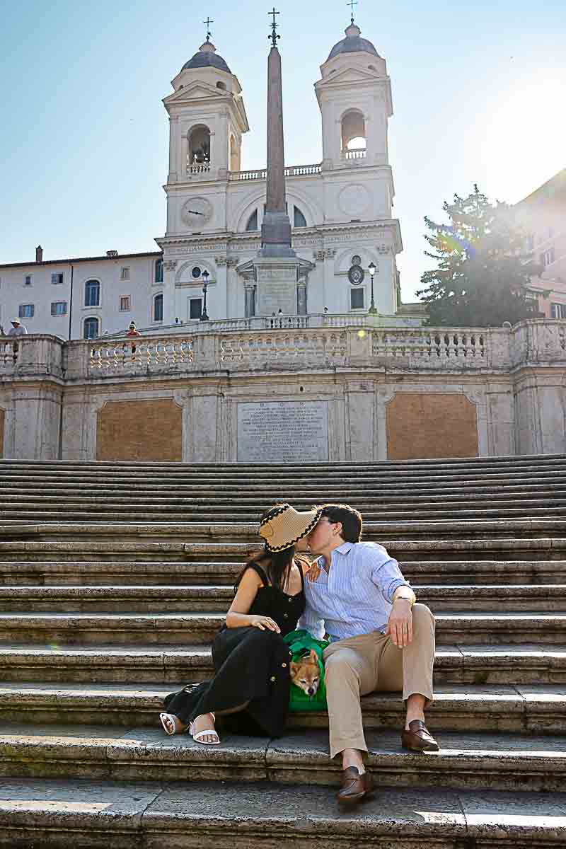 Sitting down on the staircase kissing with no one around during a Rome photoshoot city center