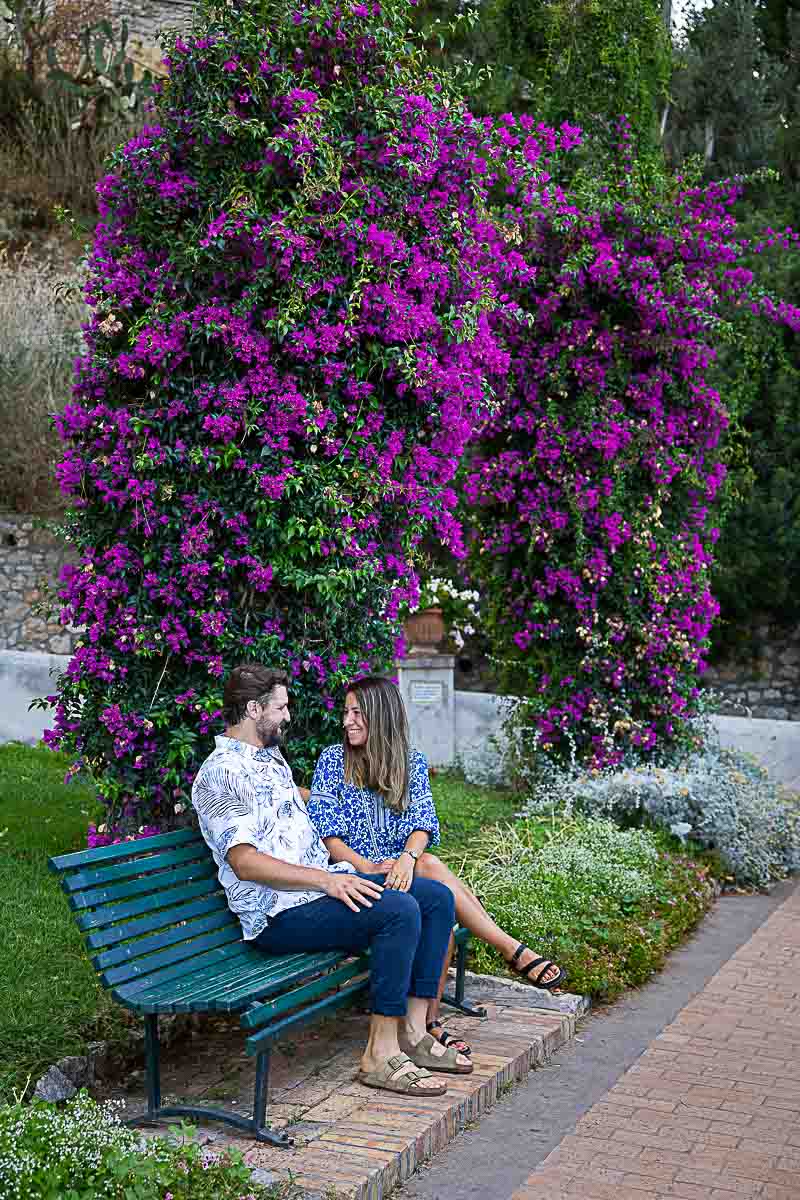 Bougainvillea fuchsia flowers photographed while sitting on a bench and talking to one another during a photographer session 