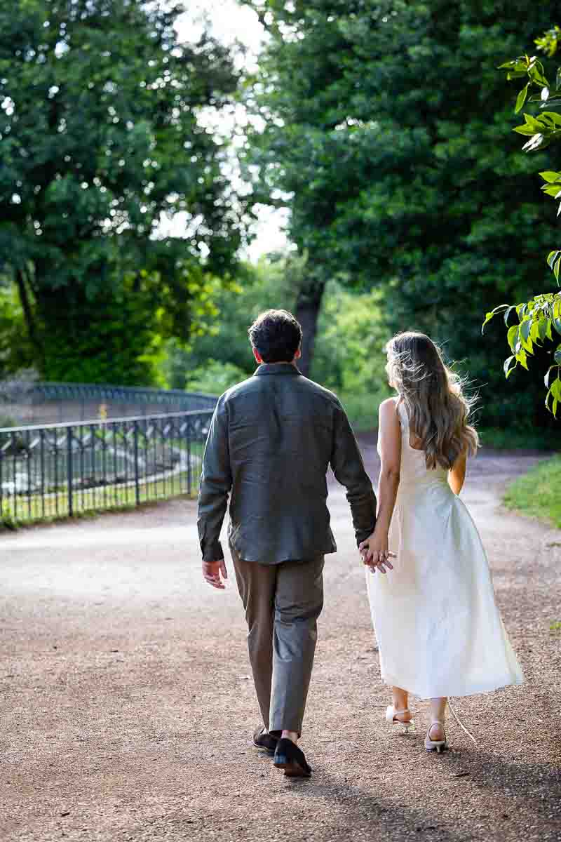 Walking together hand in hand during a photo shoot in a beautiful park like environment 