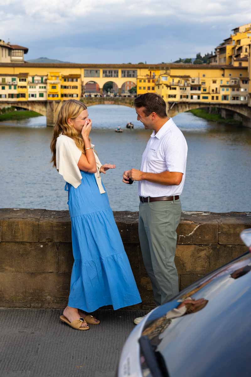The moment in which she was proposed to with the view of the city behind 