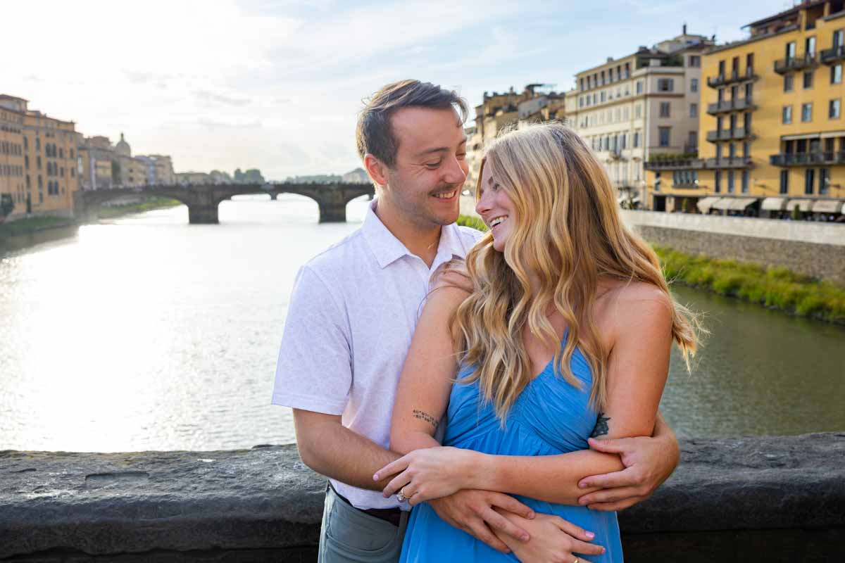 Toget at sunset during the golden hour taking pictures together as newly engaged 
