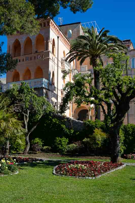 The building of villa avino photographed with the green grass of the gardens found in principessa piemonte park 
