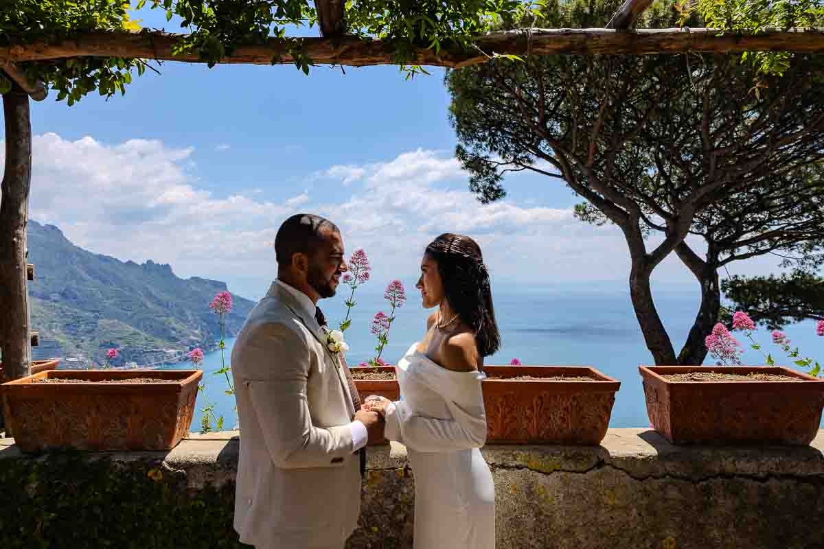 Looking at each other over the Amalfi coast as photography subjects after being married 