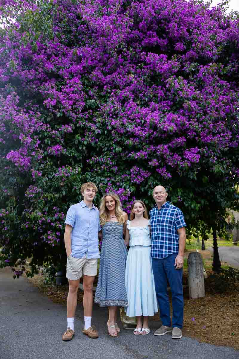 Standing in front of a bougainvillea fuchsia plant like tree that adds color and vibrancy to the roman photo shoot 