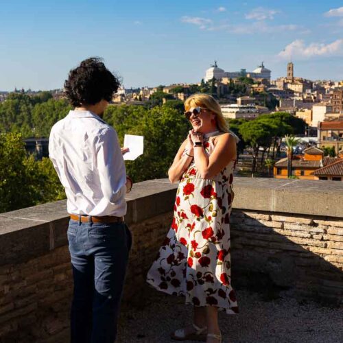 Man proposing to his girlfriend and reading a speech before asking the big question while being photographed by a a photographer in incognito