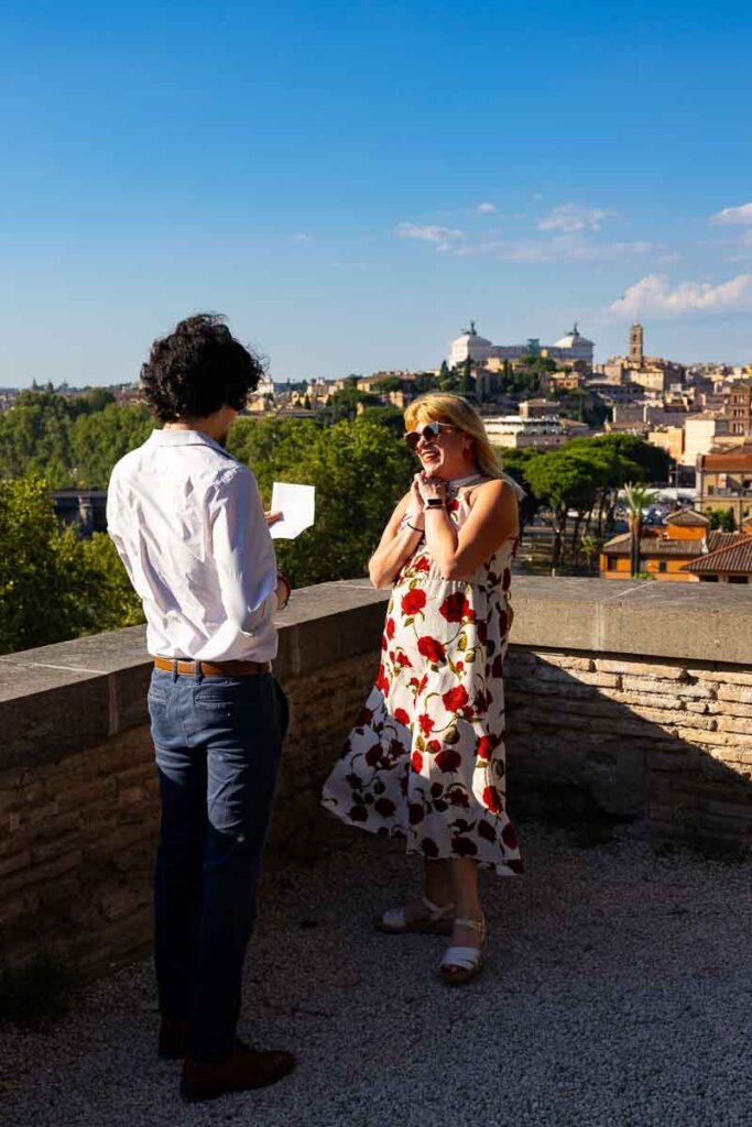 Man proposing to his girlfriend and reading a speech before asking the big question while being photographed by a a photographer in incognito