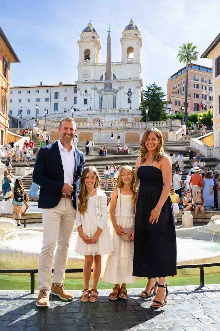 Standing beneath the staircase of Spanish steps and the church above for a photography session with a professional photographer 