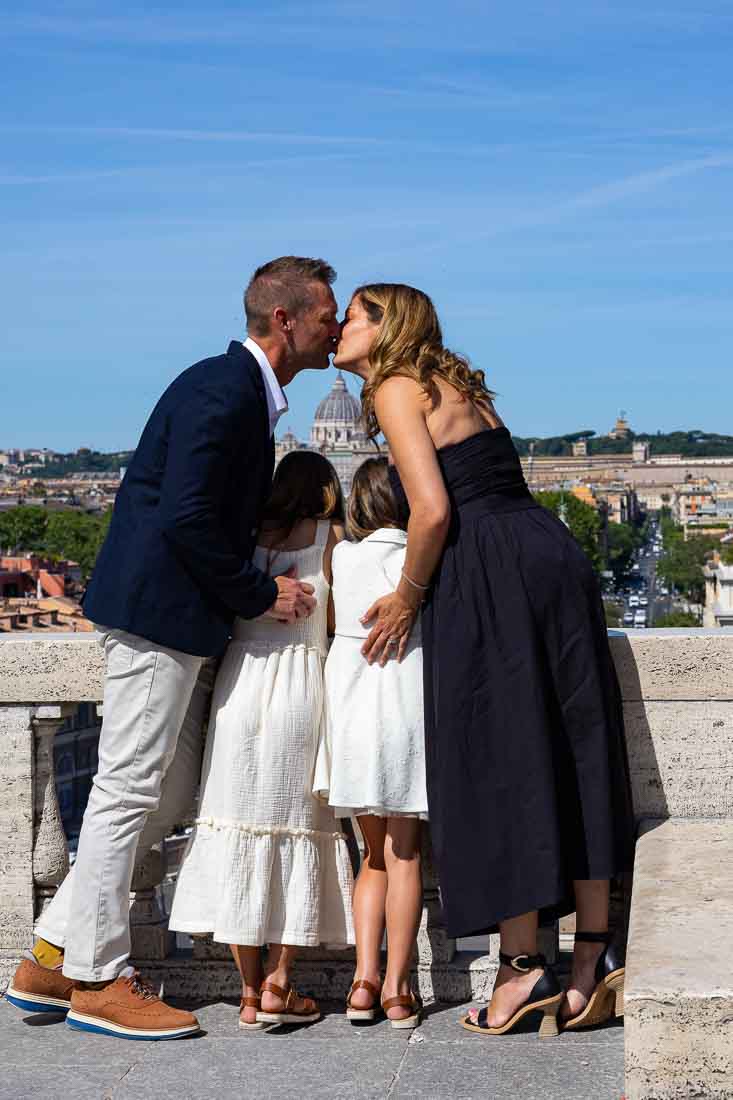 Couple kissing during a photo session while looking at the view 