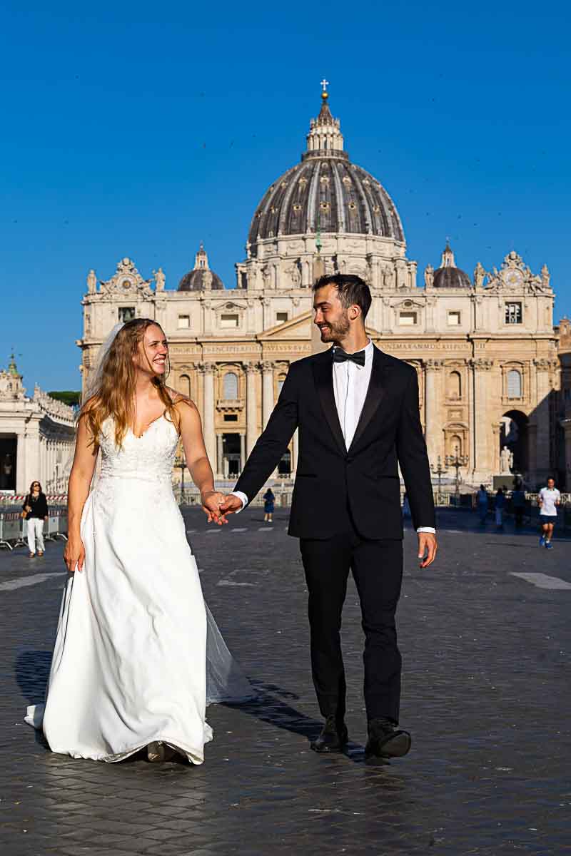 Walking hand in hand on Via della Conciliazione away from the dome of Saint Peter 