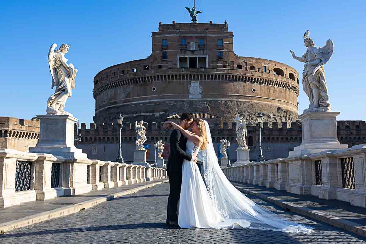 Final picture of novelli sposi on Castel Sant'Angelo bridge right in between the angel statues 