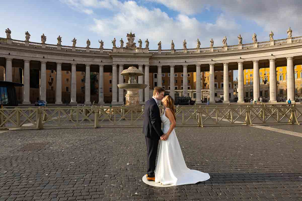 Two newlyweds positioned at the central viewpoint where the columns converge, creating a symmetrical composition through the photographer’s lens