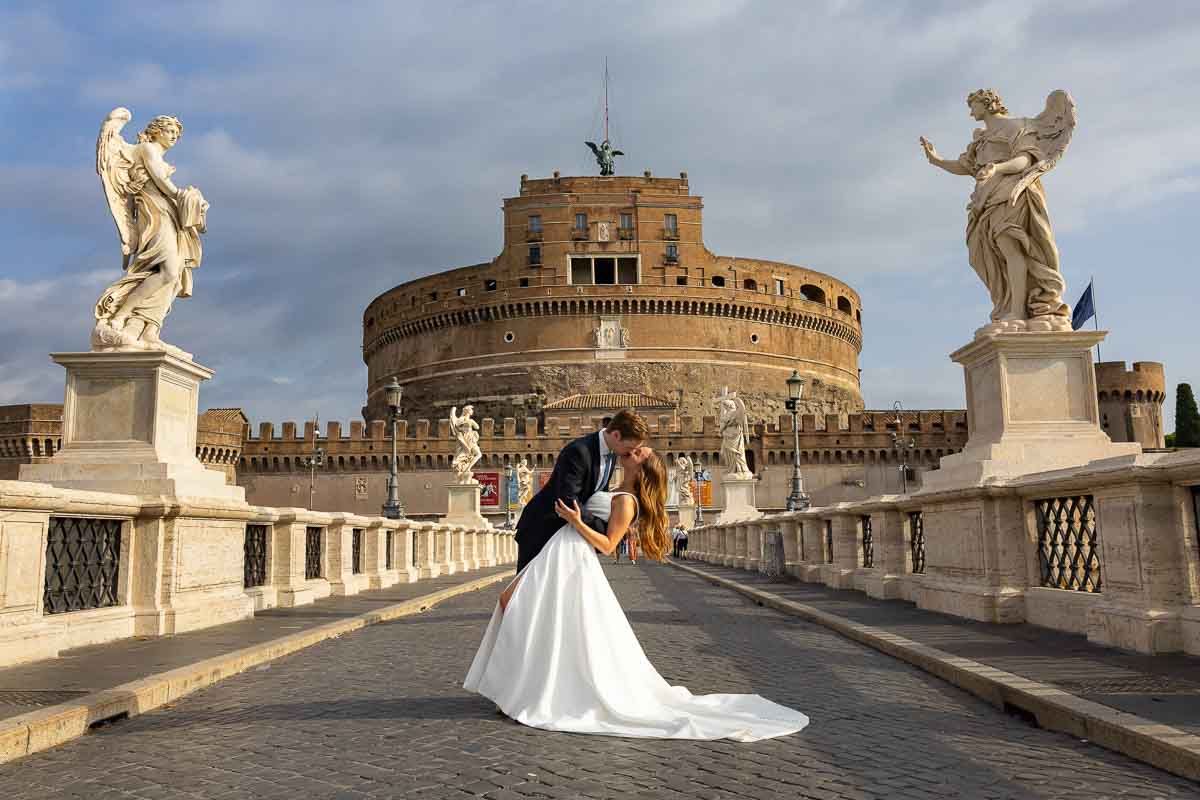 Final portrait between the sculpted angels of Ponte Sant’Angelo, using the historic bridge and surrounding cityscape to create a distinctive closing image