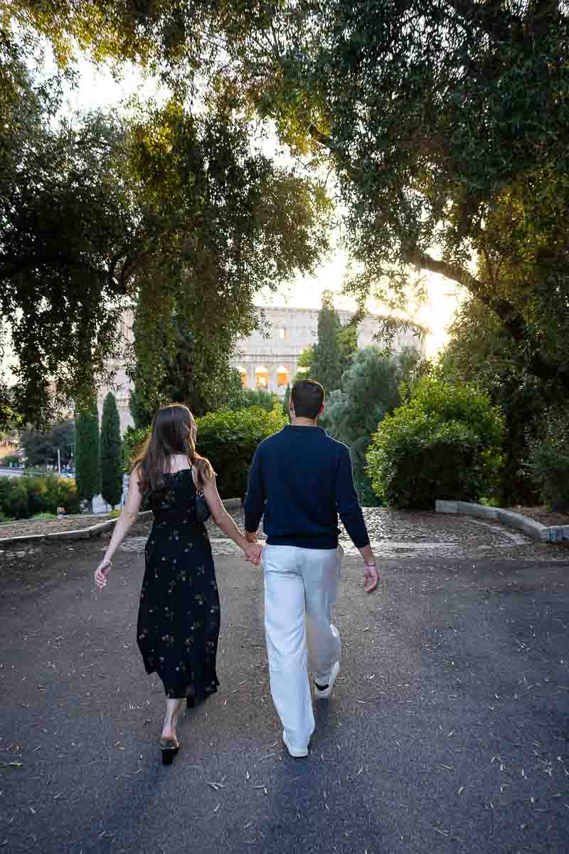 Walking to the proposal location after entering the park and romantically heading there for it to be photographed by a hidden photographer 